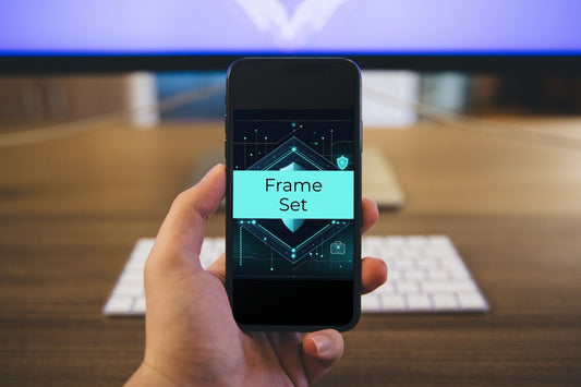 A hand holding a smartphone showing a digital editing interface labeled 'Frame Set' against a blurred office desk background with a keyboard and monitor.
